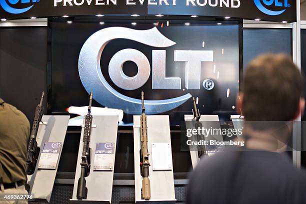 Rifles sit on display in the Colt's Manufacturing Co. Booth on the exhibition floor of the 144th National Rifle Association Annual Meetings and...