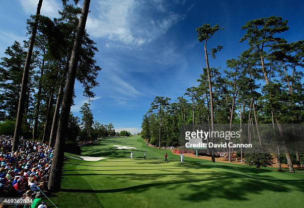 Patrons watch the play on the tenth hole during the third round of the 2015 Masters Tournament at Augusta National Golf Club on April 11, 2015 in...