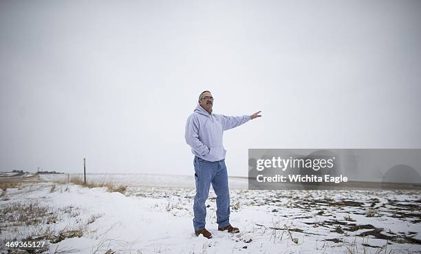 Jess Keesis, the mayor of Winner, South Dakota shows a snow-covered cornfield near Colome, South Dakota, Monday, Feb. 10, 2014 that would become a...