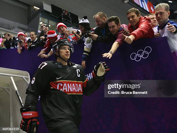 Sidney Crosby of Canada high fives fans prior to the Men's Ice Hockey Preliminary Round Group B game against Austria on day seven of the Sochi 2014...
