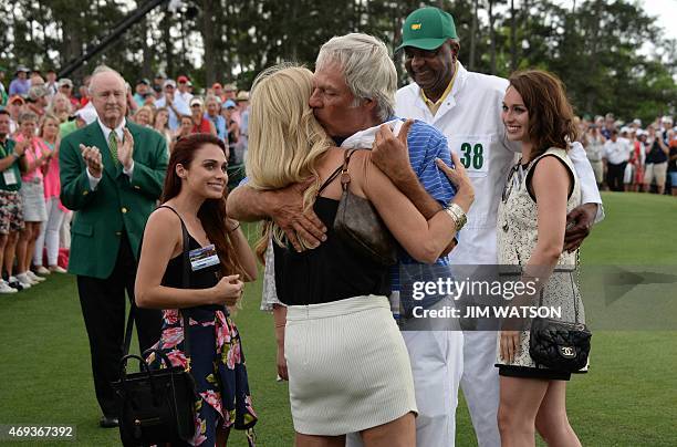 Ben Crenshaw of the US hugs his wife Julie after finishing the 18th hole during Round 2 of the 79th Masters Golf Tournament at Augusta National Golf...