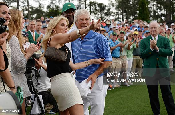 Ben Crenshaw of the US looks on as his wife Julie gestures to the crowd after he finished the 18th hole during Round 2 of the 79th Masters Golf...