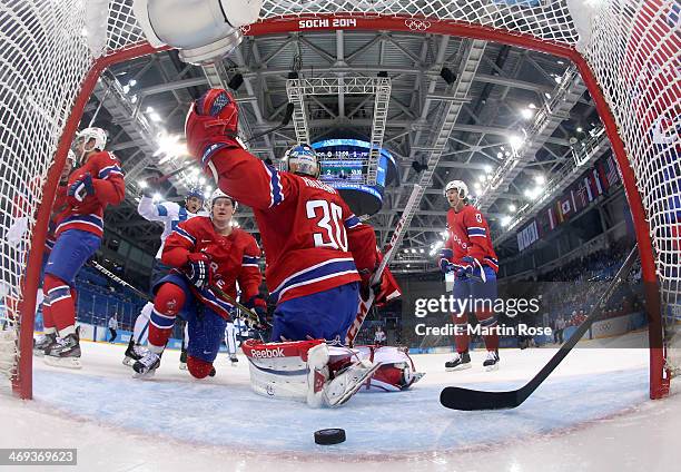 Lars Haugen of Norway gives up a goal to Lauri Korpikoski of Finland in the first period during the Men's Ice Hockey Preliminary Round Group B game...