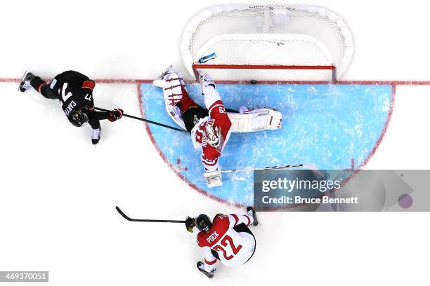 Jeff Carter of Canada scores a goal in the second period against Bernhard Starkbaum of Austria during the Men's Ice Hockey Preliminary Round Group B...