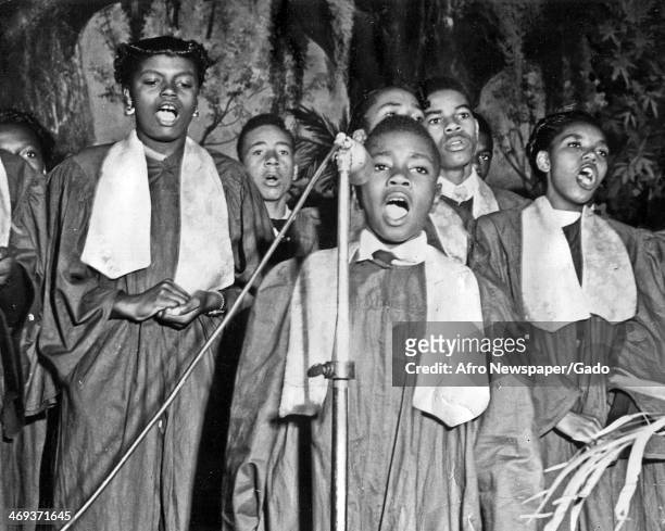 Church gospel choir with a boy at the microphone as the lead singer, 1950.