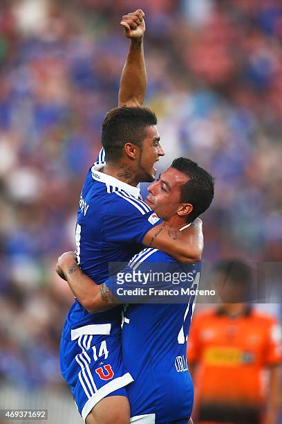 Paulo Magalhaes of Universidad de Chile celebrates with teammate Sebastian Ubilla after scoring the second goal of his team during a match between U...