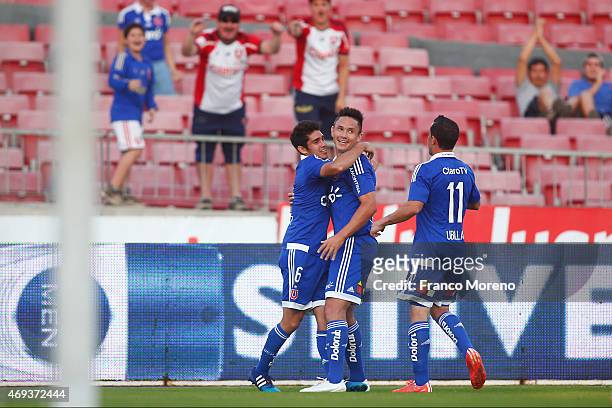Gustavo Canales of Universidad de Chile celebrates with Sebastian Martinez and Sebastian Ubilla after scoring the opening goal during a match between...