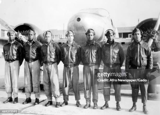 Newly commissioned single and twin engine pilots, Tuskegee Airmen, at Tuskegee Army Airfield during World War 2 with a twin engine airplane,...