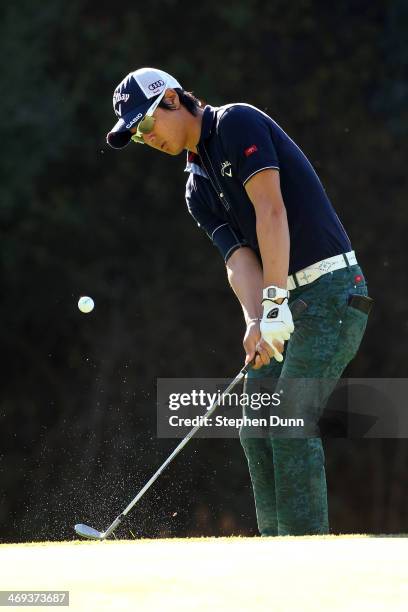 Ryo Ishikawa hits on to the green on the 12th hole in the second round of the Northern Trust Open at the Riviera Country Club on February 14, 2014 in...