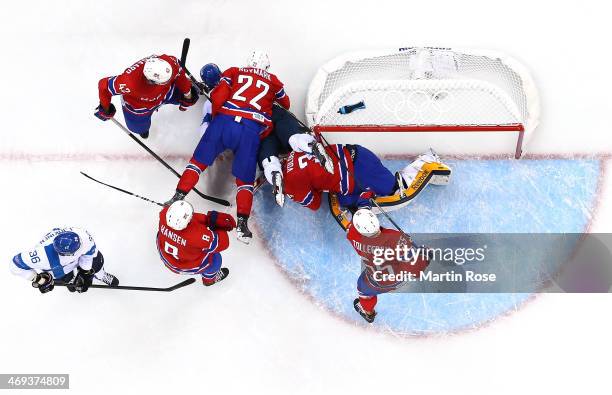 Maritn Roeymark of Norway and Olli Jokinen of Finland fall over Lars Volden of Norway in the second period during the Men's Ice Hockey Preliminary...