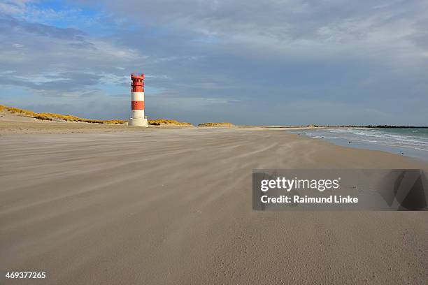 beach with lighthouse - helgoland stock-fotos und bilder