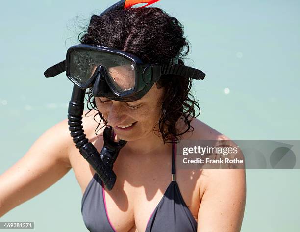 young woman with goggles and snorkel in the water - older woman wet hair stock pictures, royalty-free photos & images