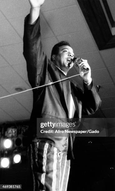 Black R & B Soul singer and songwriter, Peabo Bryson, on stage using a microphone, at an event, Remy Man, 1985.