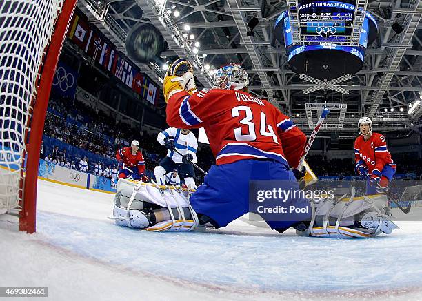 Olli Jokinen of Finland shoots and scores against Lars Volden of Norway in the second period during the Men's Ice Hockey Preliminary Round Group B...