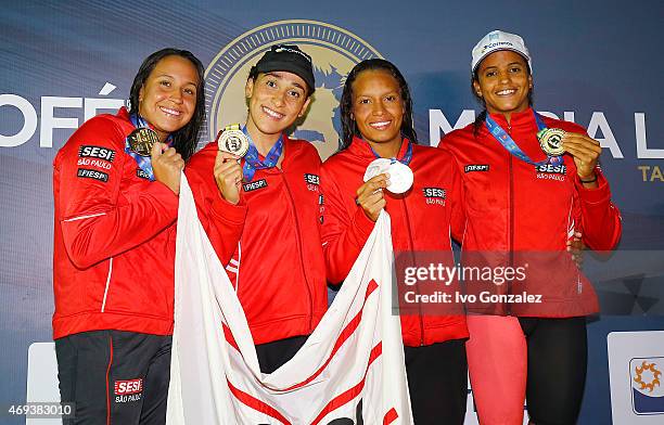Gold medal winners Jessica Cavalheiro, Daynara Ferreira de Paula, Andressa Simiao and Etiene Medeiros celebrates on the podium after swimming in the...