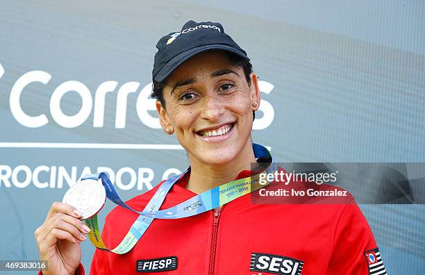Gold medal winner Daynara Ferreira de Paula celebrates on the podium after swimming in the Women's 100m freestyle final on day six of the Maria Lenk...