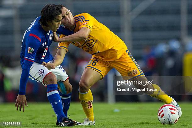 Xavier Baez of Cruz Azul fights for the ball with Jorge Torres of Tigres during a match between Cruz Azul and Tigres UANL as part of 13th round...