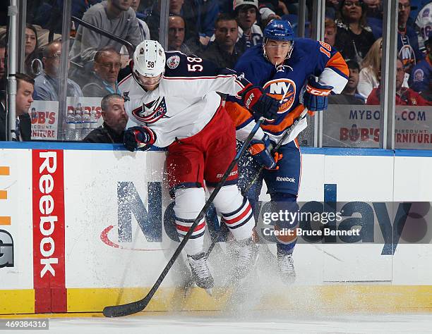 David Savard of the Columbus Blue Jackets hits Ryan Strome of the New York Islanders during the second period at the Nassau Veterans Memorial...