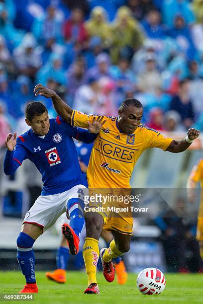 Julio Dominguez of Cruz Azul fights for the ball with Joffre Guerron of Tigres during a match between Cruz Azul and Tigres UANL as part of 13th round...