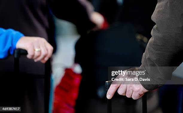 Passengers wait in longs lines for the US Airways ticketing counter at the Raleigh-Durham International Airport on February 14, 2014 in Morrisville,...