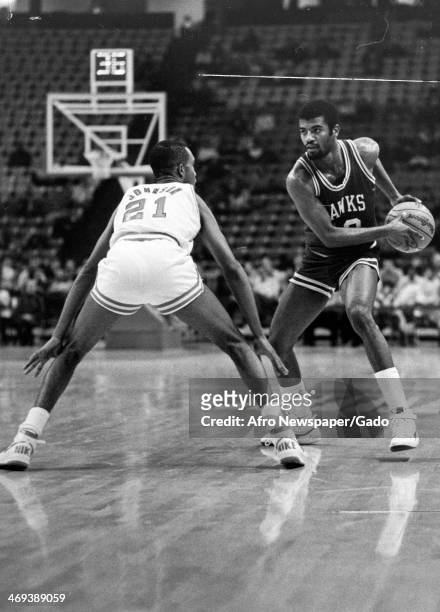 John Johnson of University of Maryland Terrapins goes head to head with Darryle Dennis of University of Maryland Hawks during a basketball game, 1970.