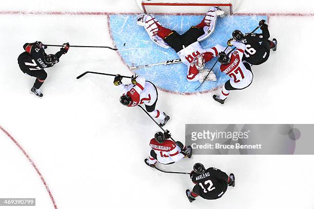 Jeff Carter of Canada scores a goal in the second period against Bernhard Starkbaum of Austria during the Men's Ice Hockey Preliminary Round Group B...