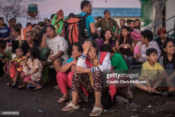 People wait for flights out of Tacloban Airport in the early hours of the morning on November 15, 2013 in Leyte, Philippines. Typhoon Haiyan which...