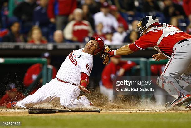 Carlos Ruiz of the Philadelphia Phillies is tagged out by catcher Wilson Ramos of the Washington Nationals while trying to score on a fielders choice...