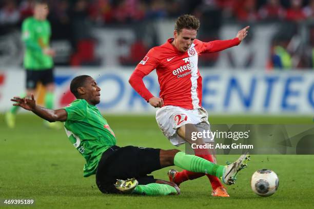 Nicolai Mueller of Mainz is challenged by Marcelo of Hannover during the Bundesliga match between 1. FSV Mainz 05 and Hannover 96 at Coface Arena on...