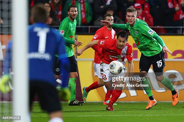 Shinji Okazaki of Mainz eludes Andre Hoffmann of Hannover during the Bundesliga match between 1. FSV Mainz 05 and Hannover 96 at Coface Arena on...