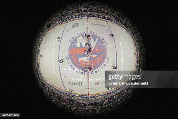 The New York Islanders and the Columbus Blue Jackets take the opening faceoff in their game at the Nassau Veterans Memorial Coliseum on April 11,...