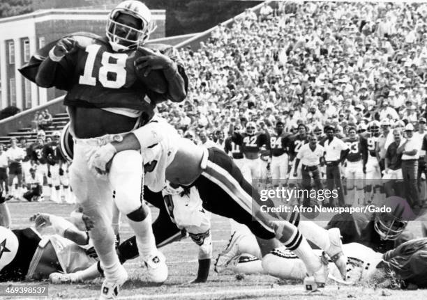 Photograph of University of Maryland's running back Charlie Wysocki being tackled, Baltimore, Maryland, 1980.