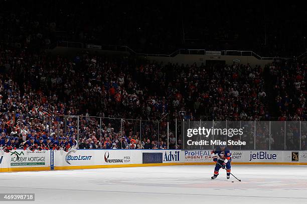 John Tavares of the New York Islanders carries the puck during the shootout against the Columbus Blue Jackets at Nassau Veterans Memorial Coliseum on...