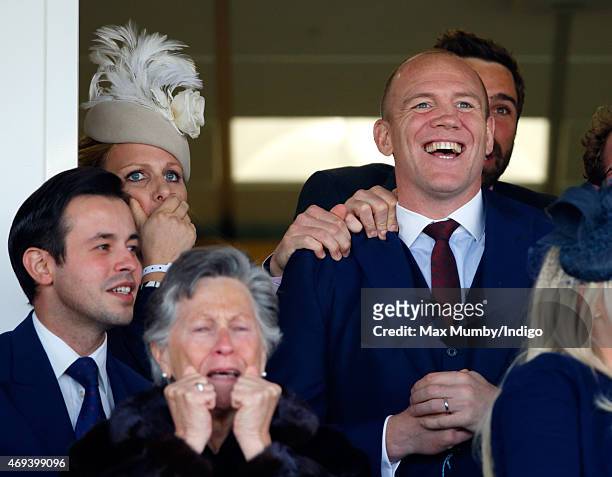 Zara Phillips and Mike Tindall watch his horse Monbeg Dude run in the Grand National as they attend day 3 'Grand National Day' of the Crabbie's Grand...