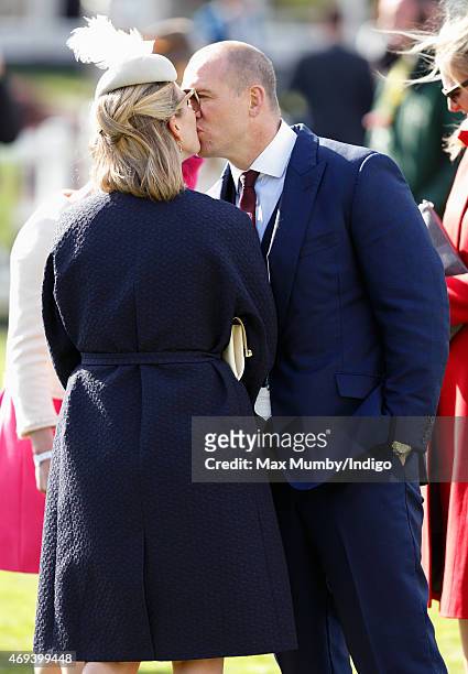 Zara Phillips and Mike Tindall kiss as they attend day 3 'Grand National Day' of the Crabbie's Grand National Festival at Aintree Racecourse on April...