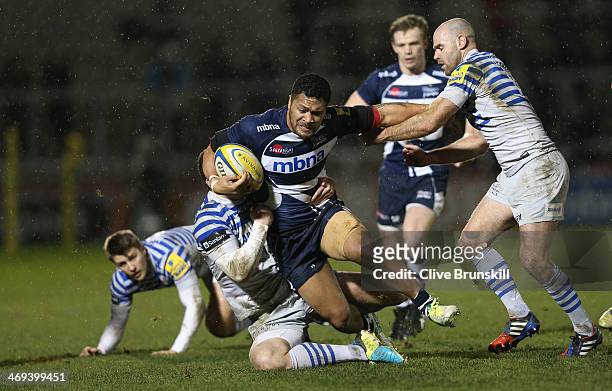 Johnny Leota of Sale is tackled by Ducan Taylor and Charlie Hodgson of Saracens during the Aviva Premiership match between Sale Sharks and Saracens...