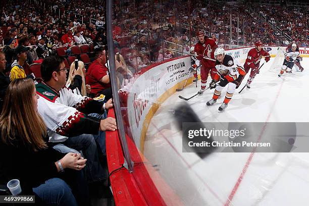 Michael Stone of the Arizona Coyotes clears the puck from Jakob Silfverberg of the Anaheim Ducks during the second period of the NHL game at Gila...