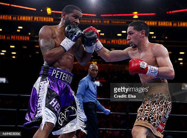Danny Garcia and Lamont Peterson exchange punches during the Premier Boxing Champions Middleweight bout at Barclays Center on April 11, 2015 in the...