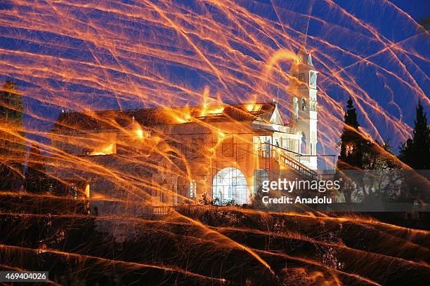 St. Mark's and Panagia Erithiani church congregations perform 'Rocket War' by firing thousands of home-made rockets across the sky during Greek...
