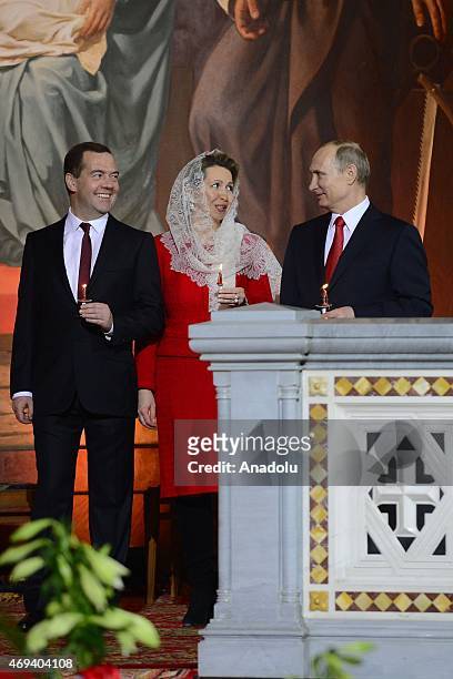 Russian President Vladimir Putin , Prime Minister Dmitry Medvedev and his wife Svetlana attend the Easter service in Christ the Savior Cathedral in...