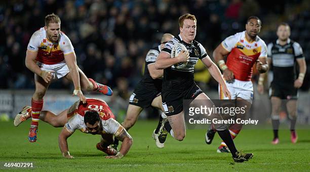 Jordan Thompson of Hull FC breaks the Catalans defensive line on his way to scoring his second half try during the Super League match between Hull FC...