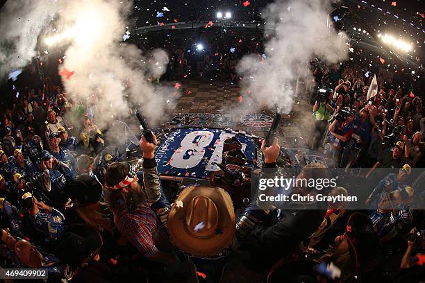 Jimmie Johnson, driver of the Lowe's Pro Services Chevrolet, celebrates with commemorative pistols, presented by Texas Motor Speedway President Eddie...