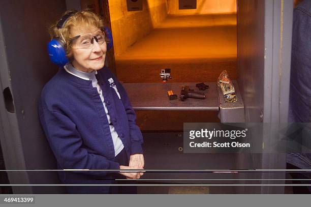 Eighty-three-year-old Evelyn Donohue listens to instructions at a shooting range before firing her pistol to qualify for an Illinois concealed carry...