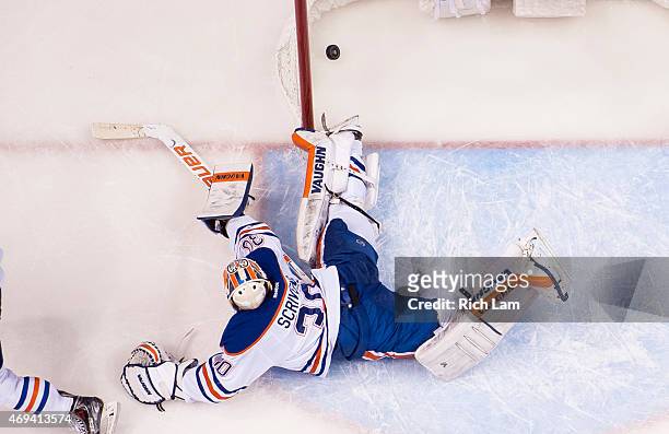 Goalie Ben Scrivens of the Edmonton Oilers watches Alexander Edler of the Vancouver Canucks shot go into the net for the game winning goal in NHL...
