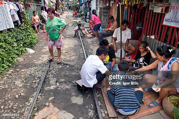 Every day life by the railway tracks in Khlong Toey slum, Bangkok, Thailand. Klong Toey, which takes up three square miles in area, has gained...