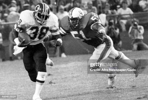 Clarence Harmon, running back for the Washington Redskins, runs with football during a game against the Miami Dolphins, 1977.