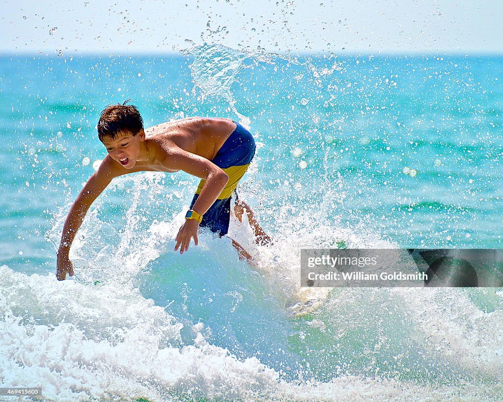 Surfer Boy Battles Waves on Florida Coast