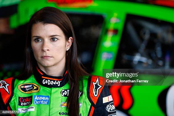 Danica Patrick, driver of the GoDaddy Chevrolet, stands in the garage during practice for the NASCAR Sprint Cup Series Sprint Unlimited at Daytona...