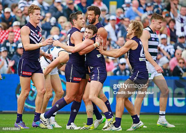 Matthew Pavlich of the Dockers celebrates with Hayden Ballantyne and David Mundy after kicking a goal during the round two AFL match between the...