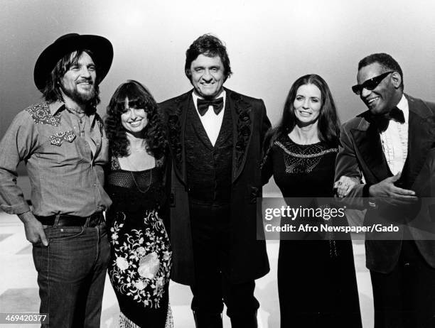 Group of musicians and singers, Johnny Cash, June Carter Cash, Waylon Jennings and Ray Charles posing in line before recording a television show,...